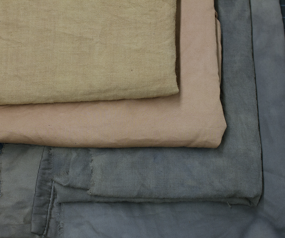 folded fabrics in shades of brick orange and greenish brown