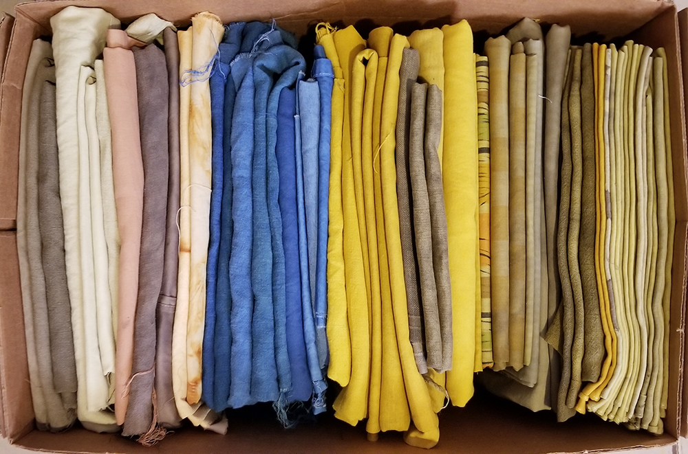 folded fabrics in a cardboard box